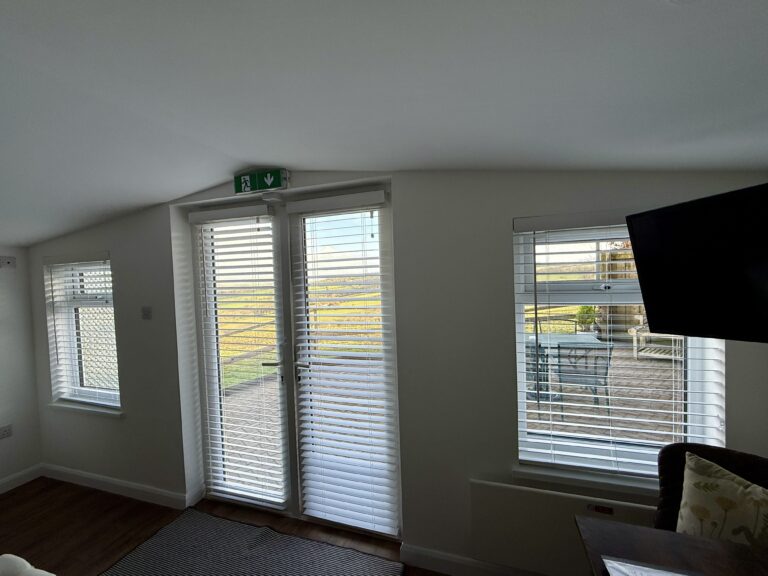 Fully glazed doors, fitted in January 2025 maximising the view and the light and white blinds to reflect the light